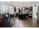 Modern kitchen with dark wood cabinets, stainless steel appliances, an island, and a cozy breakfast nook at 3241 Alhambra Cir, Hampton, GA 30228
