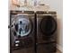 Samsung black stainless steel front load washer and dryer in the laundry room at 3241 Alhambra Cir, Hampton, GA 30228