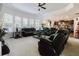 Expansive living room with neutral walls, plush carpet, comfortable seating, and ample natural light at 3241 Alhambra Cir, Hampton, GA 30228