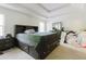 Main bedroom features a large bed, bedside table, and natural light at 3241 Alhambra Cir, Hampton, GA 30228