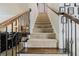 Carpeted staircase featuring wood and wrought iron banister leading to the upper level of the home at 3241 Alhambra Cir, Hampton, GA 30228
