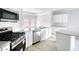Bright kitchen with stainless steel appliances, granite counters, and white cabinetry at 967 Park Place St, Social Circle, GA 30025