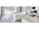 Open concept kitchen with island, stainless steel appliances, and laminate floors at 967 Park Place St, Social Circle, GA 30025