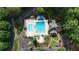 Overhead shot of a pool and recreation area with cabanas and meticulously landscaped greenery at 1045 River Pt, Suwanee, GA 30024