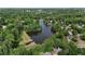 Aerial view of a lake surrounded by lush greenery and upscale residential homes at 1045 River Pt, Suwanee, GA 30024