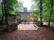 Backyard featuring stone patio, outdoor fireplace and upper deck at 1045 River Pt, Suwanee, GA 30024