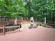 Backyard deck boasts an outdoor fireplace, seating area, and a swing set at 1045 River Pt, Suwanee, GA 30024