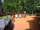 Inviting backyard deck featuring an outdoor fireplace and ample seating area for entertaining at 1045 River Pt, Suwanee, GA 30024