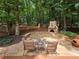 Outdoor patio features a stone fireplace, seating, and a swing set at 1045 River Pt, Suwanee, GA 30024
