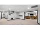 Finished basement with neutral carpet, black trim, and comfortable seating, perfect for entertaining at 1045 River Pt, Suwanee, GA 30024