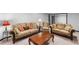 Cozy seating arrangement in basement with three plush sofas and a wooden coffee table for relaxation at 1045 River Pt, Suwanee, GA 30024