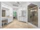 Well-lit bathroom featuring tile floors, glass shower, and elegant decor at 1045 River Pt, Suwanee, GA 30024
