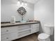 Stylish bathroom featuring a glass bowl sink, decorative mirror, and ample storage space at 1045 River Pt, Suwanee, GA 30024