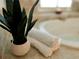 Close-up of bathroom with towels and bathtub featuring a small potted plant at 1045 River Pt, Suwanee, GA 30024