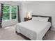 Cozy bedroom with a bed, decorative curtains, and natural light from the window at 1045 River Pt, Suwanee, GA 30024
