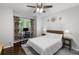 Cozy bedroom with large windows, ceiling fan, and neutral decor at 1045 River Pt, Suwanee, GA 30024