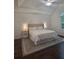 Bright bedroom featuring a neutral color palette and a tray ceiling with a ceiling fan at 1045 River Pt, Suwanee, GA 30024