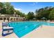 Large community pool with lap lanes and leisure seating with beautiful clubhouse at 1045 River Pt, Suwanee, GA 30024