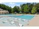 Upscale community pool with in-pool lounge chairs, sunshades, and clubhouse at 1045 River Pt, Suwanee, GA 30024