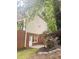 Exterior shot of a brick basement showcasing an access door surrounded by a well-maintained lawn and landscape at 1045 River Pt, Suwanee, GA 30024