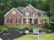 Charming two-story brick home with a beautifully landscaped front yard and inviting front porch at 1045 River Pt, Suwanee, GA 30024