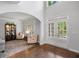 Open foyer with hardwood floors, glass panel doors, and decorative details at 1045 River Pt, Suwanee, GA 30024