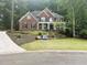 Charming two-story brick home with a manicured lawn and mature landscaping, creating an inviting curb appeal at 1045 River Pt, Suwanee, GA 30024