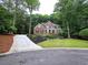 Charming brick home with a well-manicured lawn and lush landscaping at 1045 River Pt, Suwanee, GA 30024