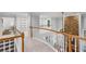 Open hallway featuring bookshelves and stone fireplace at 1045 River Pt, Suwanee, GA 30024