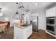 Kitchen with gas range, island, stainless appliances, and a view to the breakfast area at 1045 River Pt, Suwanee, GA 30024