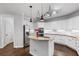 Bright kitchen with a central island, granite counters, and modern stainless appliances at 1045 River Pt, Suwanee, GA 30024