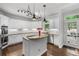 Well-appointed kitchen features stainless appliances and a central granite island at 1045 River Pt, Suwanee, GA 30024