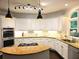 Modern kitchen with granite countertops, stainless steel appliances, and ample cabinet space at 1045 River Pt, Suwanee, GA 30024