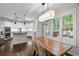 Eat-in kitchen with white cabinets, stainless appliances, and a wood table at 1045 River Pt, Suwanee, GA 30024