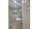A well-lit laundry room featuring a white washing machine and storage shelves at 1045 River Pt, Suwanee, GA 30024