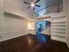 Bright, open living room with hardwood floors, ceiling fan and built-in bookshelves at 1045 River Pt, Suwanee, GA 30024