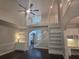 Bright living room with hardwood floors, high ceilings, and a stylish staircase and white shelving at 1045 River Pt, Suwanee, GA 30024