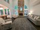 Open living room featuring a stone fireplace, large windows, and comfortable seating area at 1045 River Pt, Suwanee, GA 30024