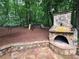 Close up of an outdoor stone fireplace with a pizza oven and seating area at 1045 River Pt, Suwanee, GA 30024