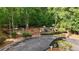 Playground is enclosed by a fence and surrounded by mature trees and parking at 1045 River Pt, Suwanee, GA 30024