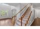 Elegant staircase with hardwood railings and a light-filled entry at 1045 River Pt, Suwanee, GA 30024