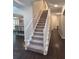 Carpeted staircase with white railings, leading to the second floor at 1045 River Pt, Suwanee, GA 30024
