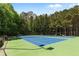 Enjoy a game on the community tennis courts, surrounded by mature trees for a private setting at 1045 River Pt, Suwanee, GA 30024