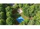 Overhead shot of tennis and basketball courts surrounded by trees on a sunny day at 1045 River Pt, Suwanee, GA 30024