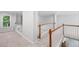 Upper hallway with neutral carpet and a wood and white railing system at 1045 River Pt, Suwanee, GA 30024