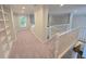 Hallway with white railing and views of living spaces below at 1045 River Pt, Suwanee, GA 30024