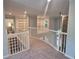 Bright open upstairs hallway with a stone fireplace at 1045 River Pt, Suwanee, GA 30024