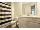Neat bathroom featuring vanity with ample storage and shower with curtain at 340 Auburn Valley Way, Auburn, GA 30011