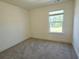 Cozy carpeted bedroom with bright window and neutral walls at 340 Auburn Valley Way, Auburn, GA 30011