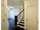 Elegant entryway with dark hardwood floors, staircase with dark wood railing, and neutral paint at 340 Auburn Valley Way, Auburn, GA 30011